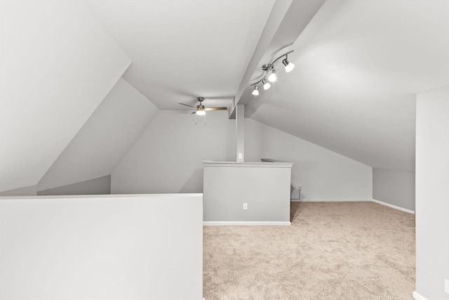 bonus room with ceiling fan, light colored carpet, and vaulted ceiling