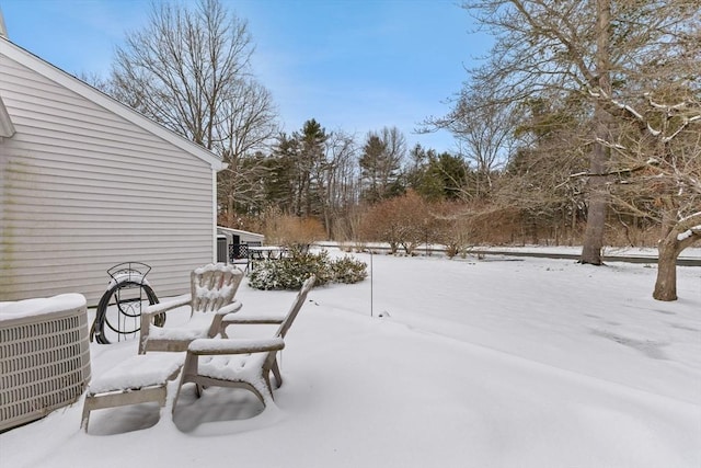 snow covered patio with cooling unit