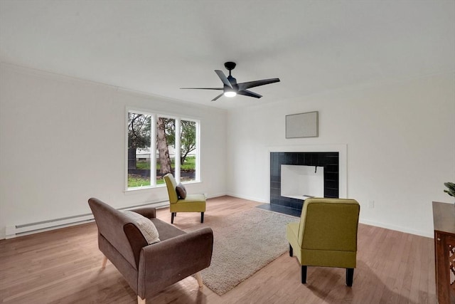 831 Morgan Rd, West Springfield, MA 01089 - living area featuring a fireplace, a baseboard radiator, wood finished floors, and ceiling fan