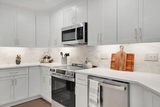 831 Morgan Rd, West Springfield, MA 01089 - kitchen featuring stainless steel appliances, light countertops, tasteful backsplash, and white cabinets