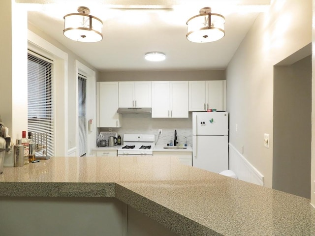 kitchen with sink, white appliances, and white cabinets