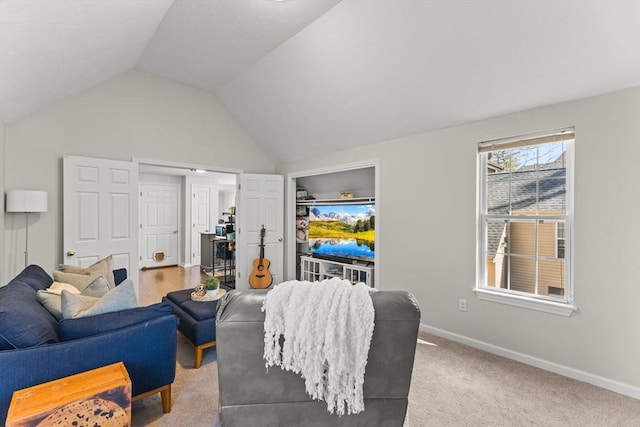 living area featuring vaulted ceiling, carpet flooring, and baseboards