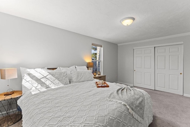 bedroom with baseboards, a closet, and carpet floors