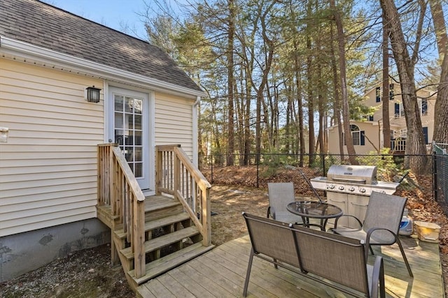 wooden deck featuring grilling area and fence