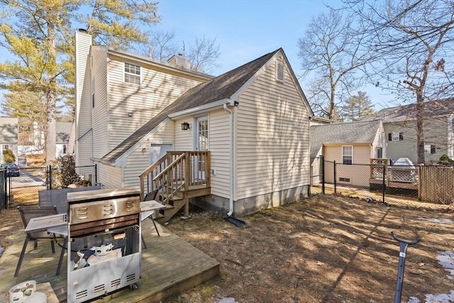 rear view of property with fence and a chimney