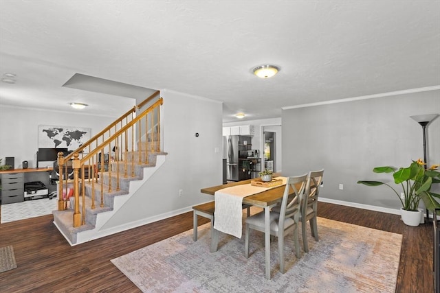 dining space featuring ornamental molding, stairs, baseboards, and wood finished floors