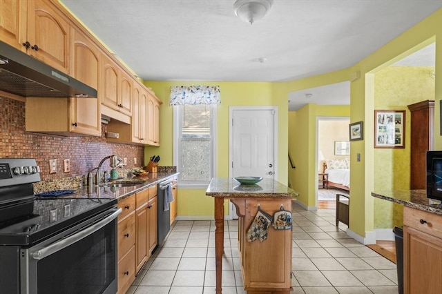 48 Northey St Unit 48, Salem, MA 01970 - kitchen featuring stainless steel appliances, under cabinet range hood, a center island, decorative backsplash, and dark stone counters
