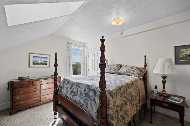 48 Northey St Unit 48, Salem, MA 01970 - bedroom with light colored carpet, a textured ceiling, vaulted ceiling, and a skylight