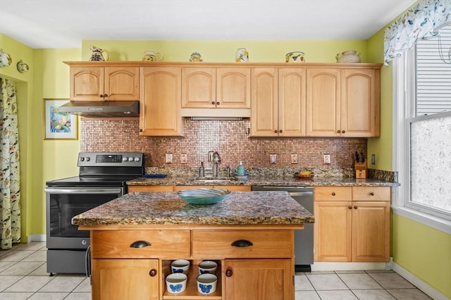 48 Northey St Unit 48, Salem, MA 01970 - kitchen with under cabinet range hood, stainless steel appliances, a sink, light tile patterned floors, and tasteful backsplash