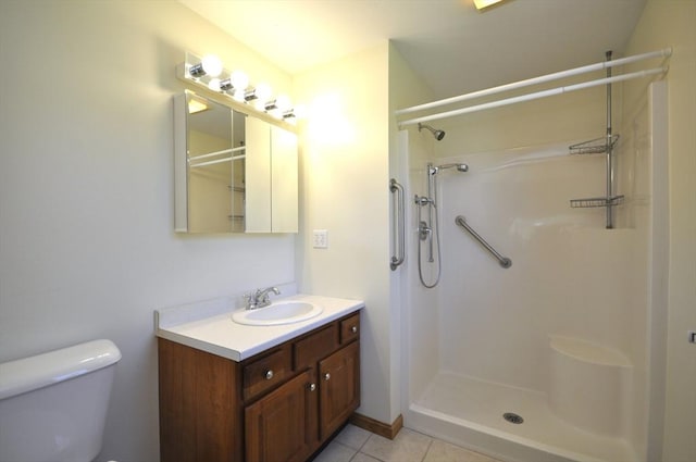 full bath with vanity, walk in shower, tile patterned floors, and toilet