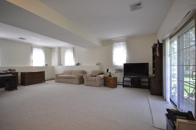 living room with visible vents, carpet, and a wealth of natural light