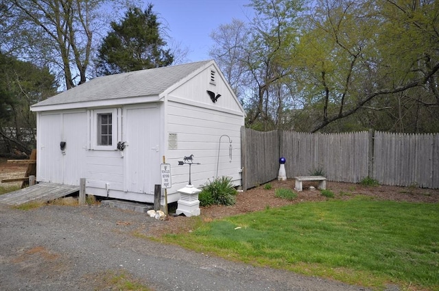 view of shed featuring fence