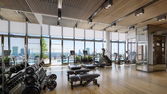 682 Atlantic Ave Unit 37G, Boston, MA 02111 - workout area featuring wood finished floors, a city view, expansive windows, and a towering ceiling