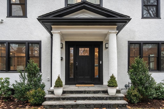 property entrance featuring stucco siding