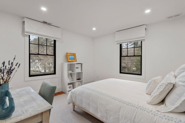 bedroom featuring recessed lighting, visible vents, and multiple windows