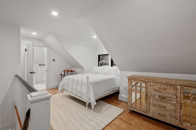 bedroom with recessed lighting, baseboards, wood finished floors, and vaulted ceiling