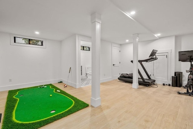 exercise area featuring recessed lighting, wood finished floors, and baseboards