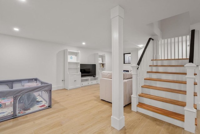 staircase with recessed lighting, wood finished floors, and baseboards