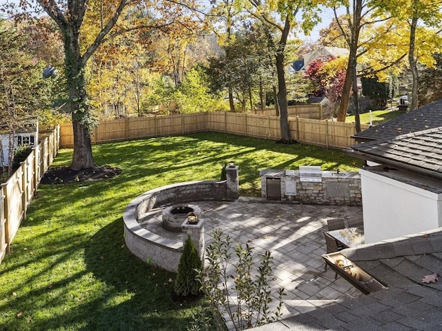 view of yard with area for grilling, a patio, an outdoor fire pit, and a fenced backyard