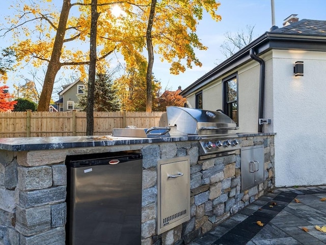 view of patio / terrace with area for grilling and fence