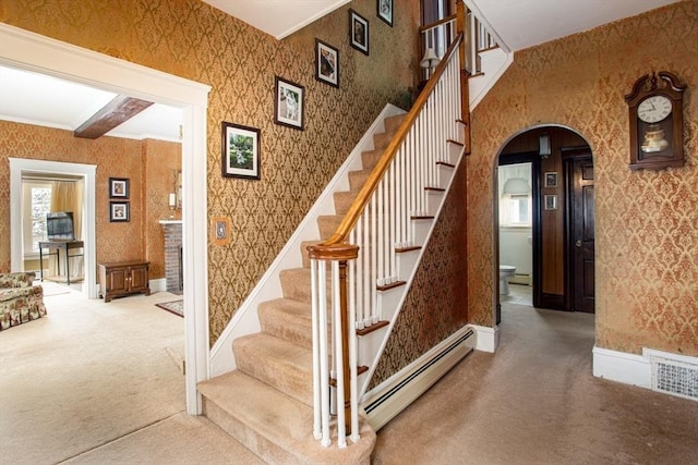 stairway featuring plenty of natural light, carpet floors, and a baseboard heating unit