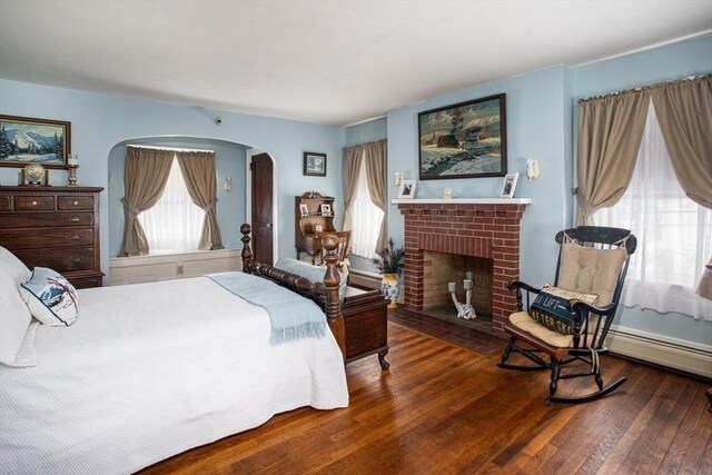 bedroom featuring hardwood / wood-style flooring and a fireplace