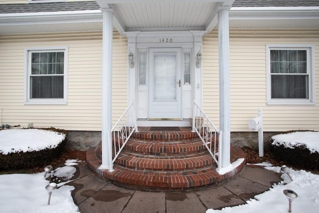 view of snow covered property entrance