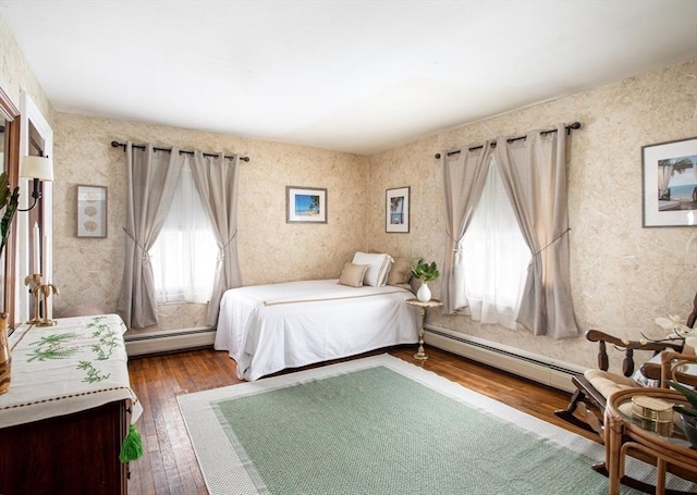 bedroom featuring hardwood / wood-style floors and a baseboard radiator