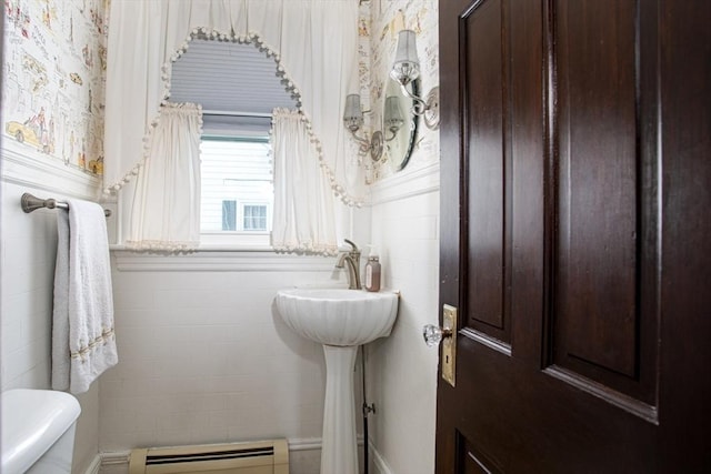 bathroom featuring toilet and a baseboard heating unit