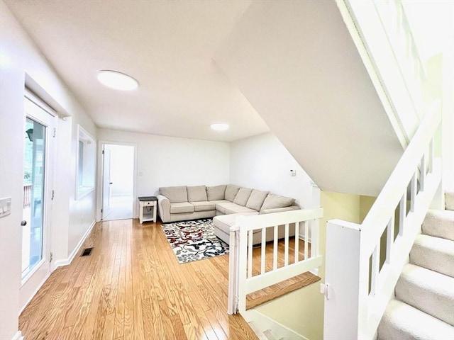 194 Captain Eames Cir Unit 194, Ashland, MA 01721 - living area with hardwood / wood-style flooring, stairway, and baseboards