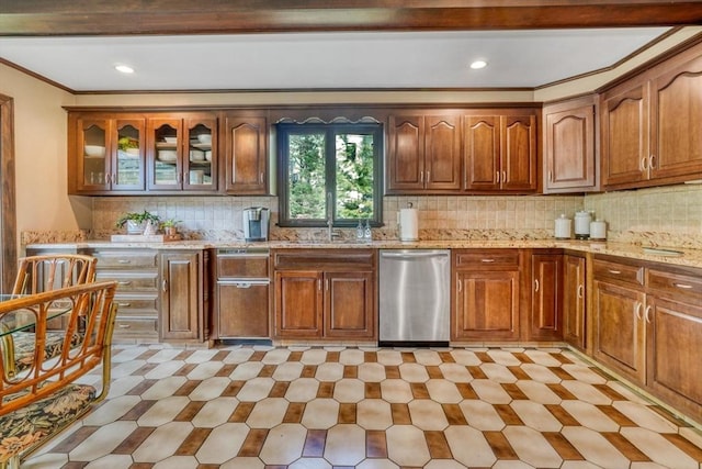 kitchen with tasteful backsplash, stainless steel dishwasher, ornamental molding, and light stone counters