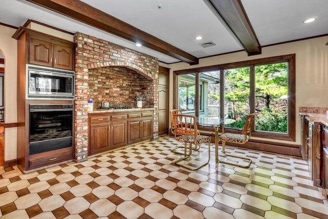 kitchen featuring beamed ceiling and appliances with stainless steel finishes