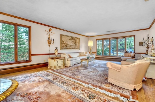 living room featuring ornamental molding, a wealth of natural light, and light hardwood / wood-style flooring