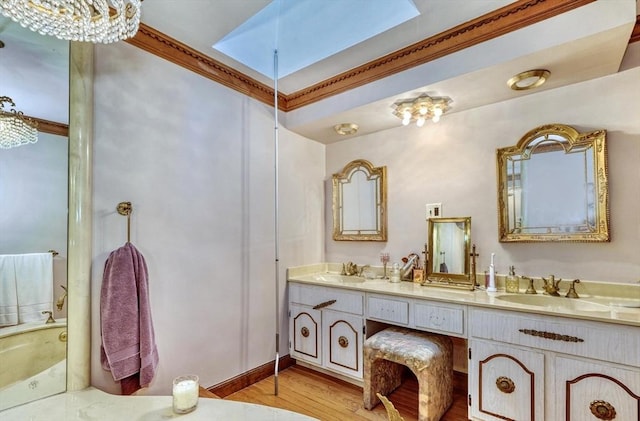 bathroom with hardwood / wood-style floors, vanity, crown molding, and a notable chandelier