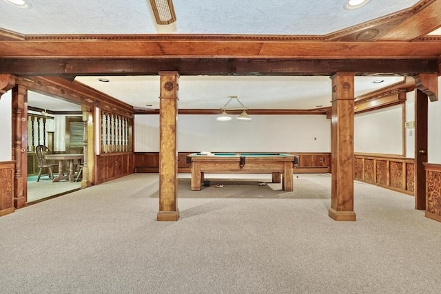 rec room with wood walls, ornamental molding, light colored carpet, and pool table