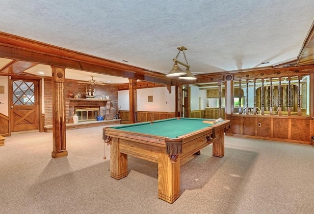 game room featuring billiards, a brick fireplace, ceiling fan, a textured ceiling, and light colored carpet