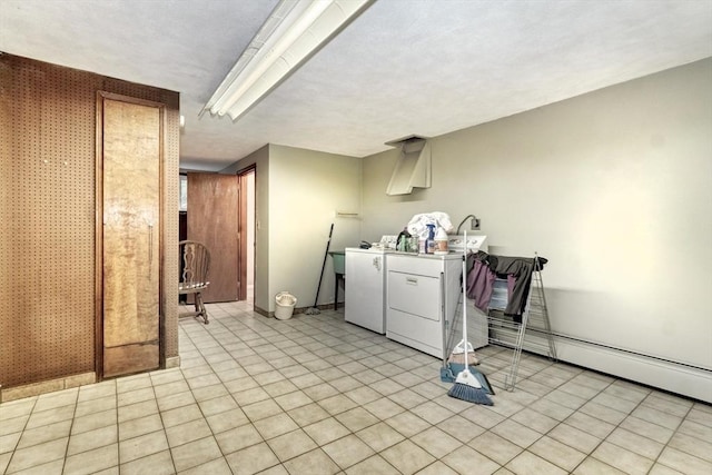 laundry room featuring independent washer and dryer and light tile patterned floors