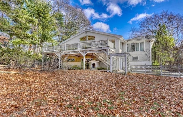 back of house with a wooden deck