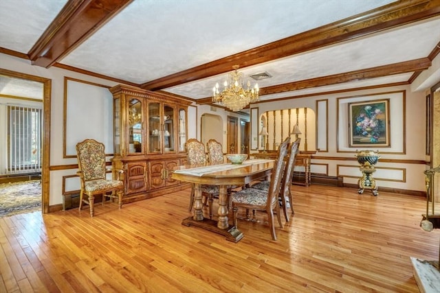 dining room featuring beam ceiling, crown molding, light hardwood / wood-style flooring, and a notable chandelier