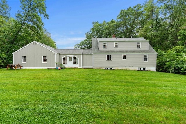 1857 Great Pond Rd, North Andover, MA 01845 - rear view of property featuring a lawn, roof with shingles, and a chimney