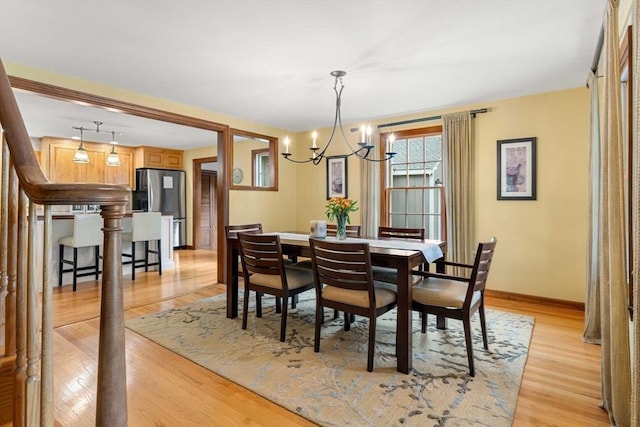 1857 Great Pond Rd, North Andover, MA 01845 - dining space featuring a chandelier and light wood-type flooring