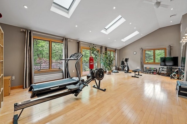 workout area featuring high vaulted ceiling and light hardwood / wood-style flooring