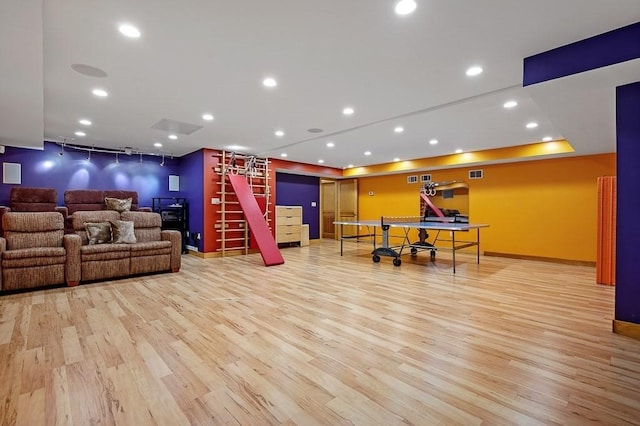 recreation room with light hardwood / wood-style floors