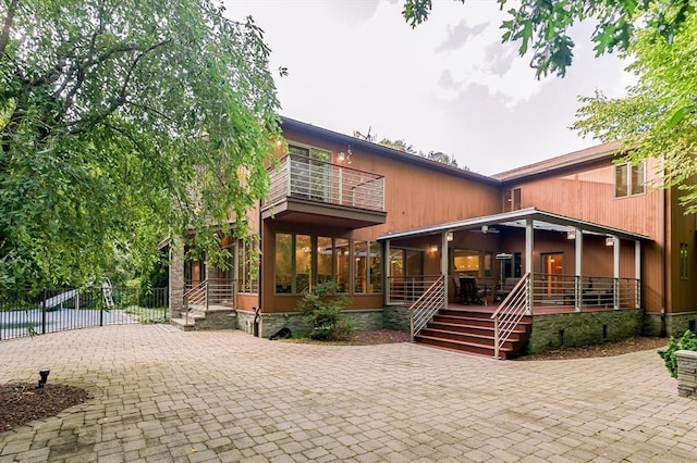 back of house featuring a balcony