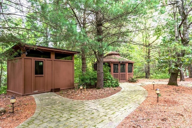 view of yard with a gazebo and an outdoor structure