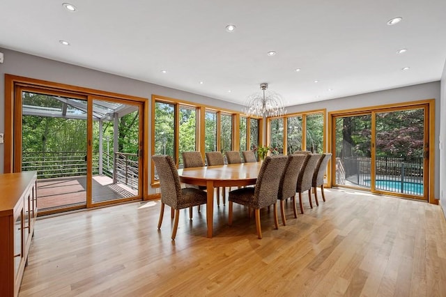 dining space with a chandelier and light hardwood / wood-style floors