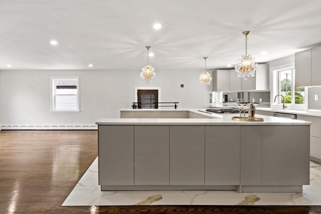23 Donna St, Westport, MA 02790 - kitchen with modern cabinets, recessed lighting, a chandelier, gray cabinets, and a baseboard radiator