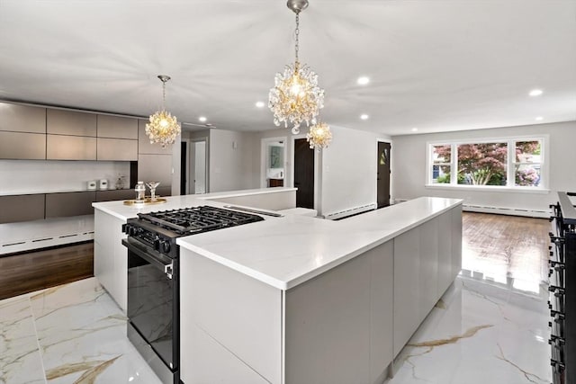 23 Donna St, Westport, MA 02790 - kitchen with black range with gas stovetop, modern cabinets, a chandelier, a baseboard radiator, and recessed lighting