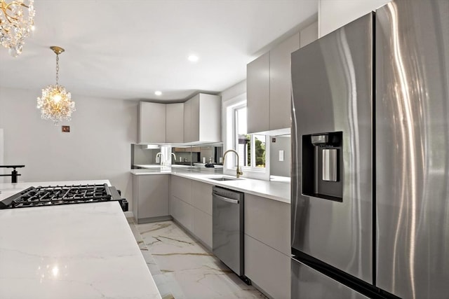 23 Donna St, Westport, MA 02790 - kitchen with stainless steel appliances, a chandelier, a sink, modern cabinets, and light marble finish floors