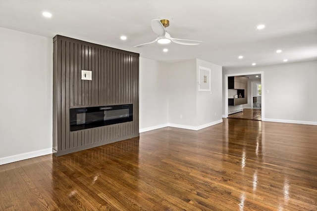 23 Donna St, Westport, MA 02790 - unfurnished living room with wood finished floors, recessed lighting, a glass covered fireplace, baseboards, and a ceiling fan